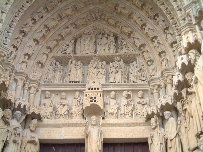 Porche gauche - tympan et statue de St Firmin